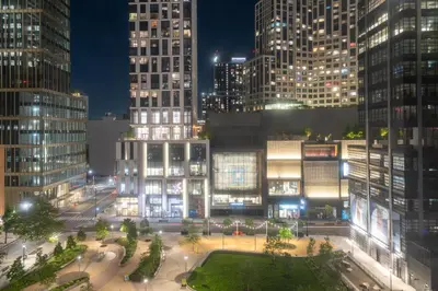 a view of a city at night with tall buildings at Aloft New York Brooklyn in Brooklyn
