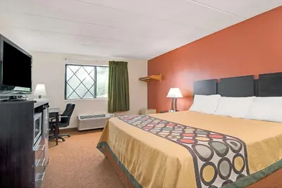 a hotel room with a bed and a television at Super 8 by Wyndham Stamford/New York City Area in Stamford