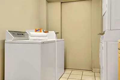 a white washer and dryer in a room at Super 8 by Wyndham Stamford/New York City Area in Stamford