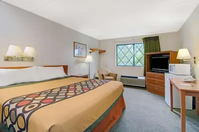 a hotel room with a large bed and a television at Super 8 by Wyndham Stamford/New York City Area in Stamford