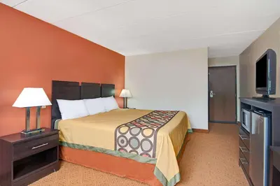 a hotel room with a bed and a flat screen tv at Super 8 by Wyndham Stamford/New York City Area in Stamford