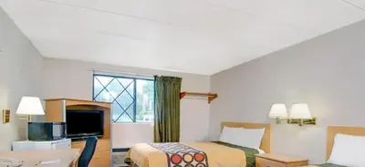 a hotel room with two beds and a window at Super 8 by Wyndham Stamford/New York City Area in Stamford