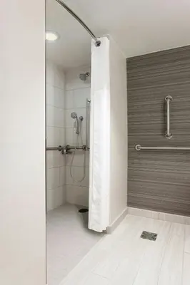 a shower with a glass door in a bathroom at Newark Liberty International Airport Marriott in Newark