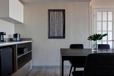 a kitchen and dining room with a table and chairs at New York LaGuardia Airport Marriott in Queens
