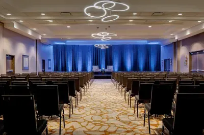 a room with rows of tables and chairs at New York LaGuardia Airport Marriott in Queens