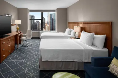 a hotel room with two beds and a television at Courtyard New York Manhattan/Midtown East in New York