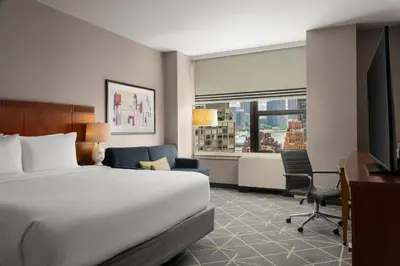 a hotel room with a bed and a desk at Courtyard New York Manhattan/Midtown East in New York