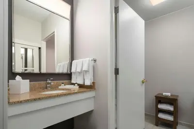 a bathroom with a sink and a mirror at Courtyard New York Manhattan/Midtown East in New York