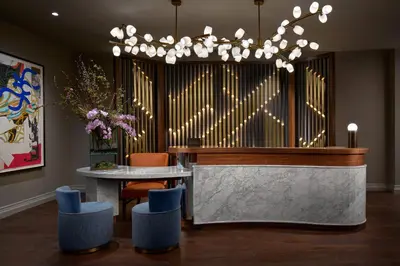 a large organ in a room with a table and chairs at The Opus Westchester, Autograph Collection in White Plains