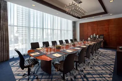 a large conference room with a long table and chairs at The Opus Westchester, Autograph Collection in White Plains