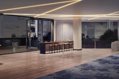 a lobby with a group of tables and chairs at Marriott Springfield Downtown in Springfield