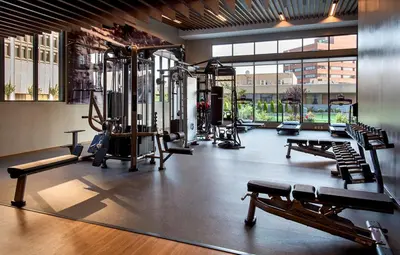 a gym with treadmills and machines in a building at Marriott Springfield Downtown in Springfield