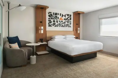 a bedroom with a large bed and a chair at Marriott Springfield Downtown in Springfield