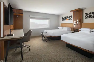a hotel room with two beds and a desk at Marriott Springfield Downtown in Springfield