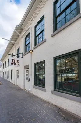 a white building with a sign that reads the water at The Wick, Hudson, a Tribute Portfolio Hotel in Hudson