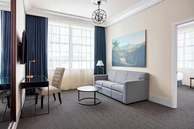 a living room with a couch and a table at The Wick, Hudson, a Tribute Portfolio Hotel in Hudson
