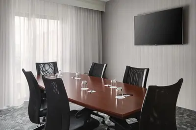 a conference room with a wooden table and chairs at Courtyard by Marriott Mahwah in Mahwah