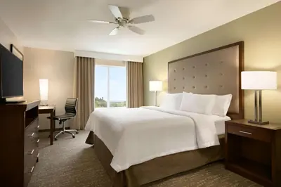 a hotel room with a large bed and a window at Homewood Suites By Hilton Hartford Manchester in Manchester