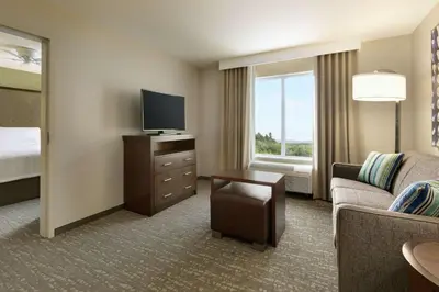 a hotel room with a couch and a tv and a bed at Homewood Suites By Hilton Hartford Manchester in Manchester