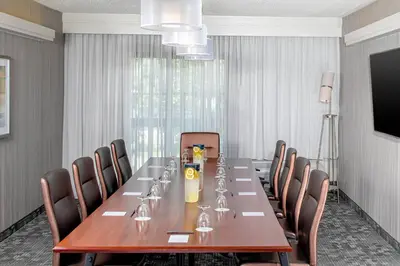 a conference room with a long table and chairs at Courtyard By Marriott Jersey City Newport in Jersey City