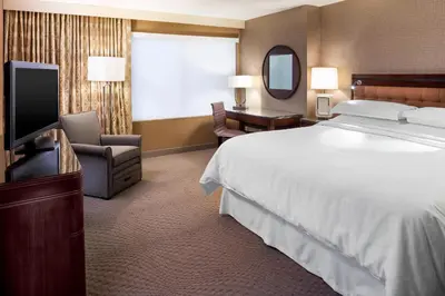 a hotel room with a bed and a television at Sheraton Hartford South in Rocky Hill