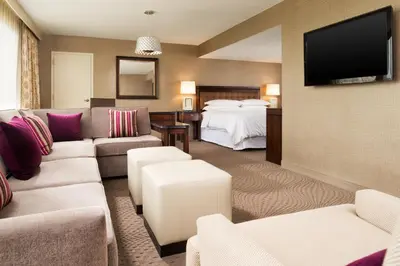 a hotel room with a couch and a bed at Sheraton Hartford South in Rocky Hill