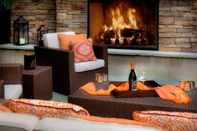 a table with a bottle of wine and a fireplace at Trumbull Marriott Shelton in Trumbull