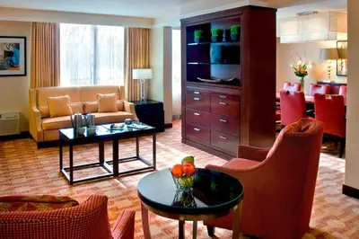 a living room with a couch and a table and chairs at Trumbull Marriott Shelton in Trumbull