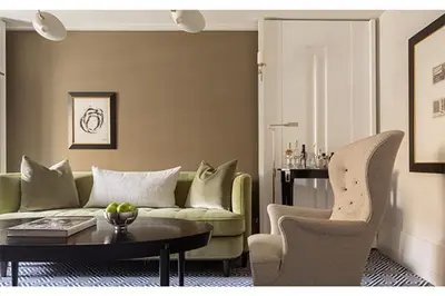 a living room with a couch and a table and chairs at The Carlyle, A Rosewood Hotel in New York