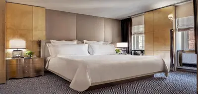 a bedroom with a large white bed in a room at The Carlyle, A Rosewood Hotel in New York