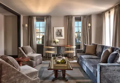 a living room with a couch and chairs and a table at The Carlyle, A Rosewood Hotel in New York