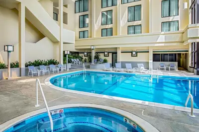a pool at a hotel with chairs and a hotel at Marriott Park Ridge in Park Ridge