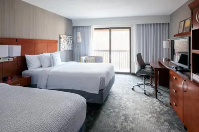 a hotel room with two beds and a television at Courtyard Parsippany in Parsippany
