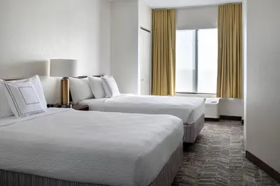 a hotel room with two beds and a window at SpringHill Suites Danbury in Danbury