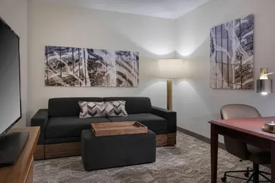 a living room with a couch and a table at SpringHill Suites Danbury in Danbury