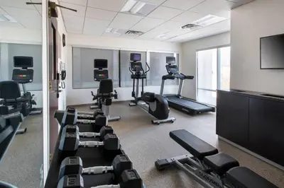 a gym with several treadmills and exercise machines at SpringHill Suites Danbury in Danbury