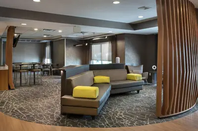 a living room with a couch and a table at SpringHill Suites Danbury in Danbury