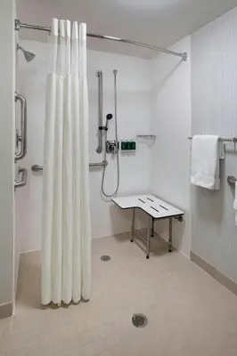 a bathroom with a shower with a shower curtain at Courtyard by Marriott Fishkill in Fishkill