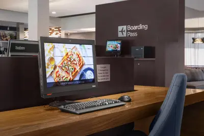 a desk with a computer monitor and a keyboard and mouse at Courtyard by Marriott Fishkill in Fishkill