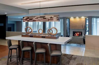 a kitchen with a island with a fireplace in a house at Courtyard by Marriott Tarrytown Westchester County in Tarrytown