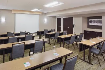 a classroom with tables and chairs and a whiteboard at Courtyard by Marriott Tarrytown Westchester County in Tarrytown