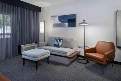 a living room with a couch and a chair at Courtyard by Marriott Norwalk in Norwalk