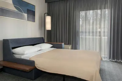 a hotel room with a bed and a window at Courtyard by Marriott Rye in Rye