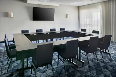 a conference room with a large table and chairs at Courtyard by Marriott Rye in Rye