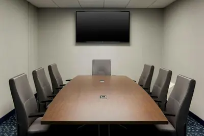 a conference room with a large wooden table and chairs at Courtyard by Marriott Rye in Rye
