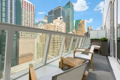 a balcony with chairs and a view of the city at AC Hotel by Marriott New York Times Square in New York