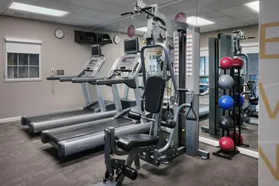 a gym with rows of treadmills and machines at Residence Inn Poughkeepsie in Poughkeepsie