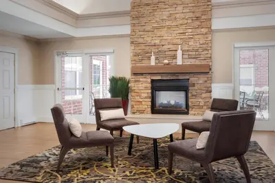 a living room with chairs and a fireplace at Residence Inn Poughkeepsie in Poughkeepsie