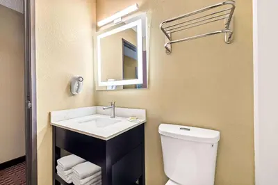 a bathroom with a toilet and a sink and a mirror at Super 8 by Wyndham Amsterdam in Amsterdam