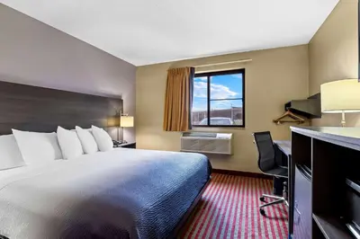 a hotel room with a large bed and a window at Super 8 by Wyndham Amsterdam in Amsterdam